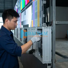 Kỹ thuật viên Đại Nam Groups thi công lắp đặt màn hình led P2.5 trong nhà chuyên nghiệp, đang ghép cabinet nhôm đúc lên hệ thống khung thép gia cố.